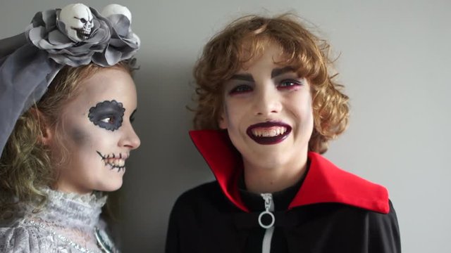 Children in costumes of the vampire dracula and the dead bride of Frankenstein. Halloween tradition, all saints evening