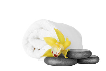 Fototapeta na wymiar Fresh towel, spa stones and exotic flower isolated on white
