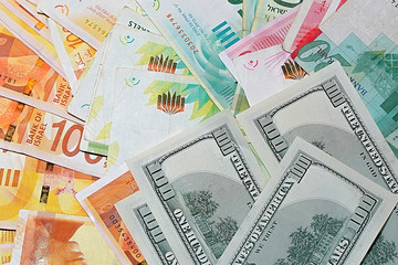 Stack of the new Israeli money bills (banknotes) and money american hundred dollar bills.    