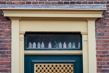 Models of traditional Dutch houses as decorations on the front door