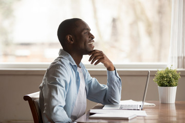 Happy young african american guy visualizing future, weekend or vacation time.