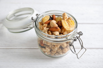 Tasty homemade granola on white wooden table. Healthy breakfast