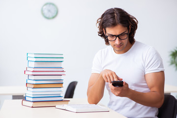 Young male student sitting in the classroom