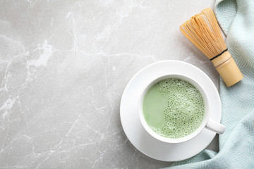 Tasty matcha green tea latte on light grey marble table, flat lay. Space for text