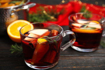 Tasty mulled wine with spices on wooden table