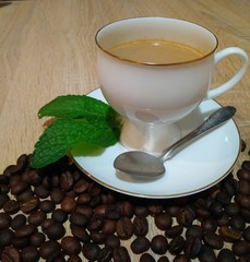 cup of coffee with whipped cream on wooden background