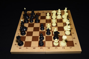 Wooden chess board and the chessmen as a strategy concept