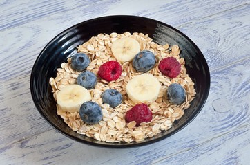 Healthy sweet breakfast. Oatmeal with blueberries, raspberries and bananas.
