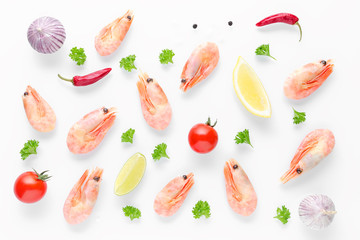 food background with cooked shrimps, chili, garlic and lemon on white background
