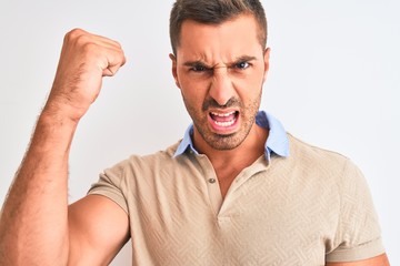 Young handsome man wearing elegant t-shirt over isolated background annoyed and frustrated shouting with anger, crazy and yelling with raised hand, anger concept