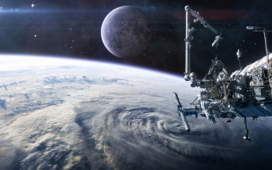 ISS in open space against the background of the Earth's landscape and the Moon. Solar system. Science fiction. Elements of this image furnished by NASA