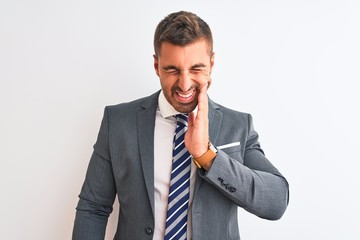 Young handsome business man wearing suit and tie over isolated background touching mouth with hand with painful expression because of toothache or dental illness on teeth. Dentist concept.
