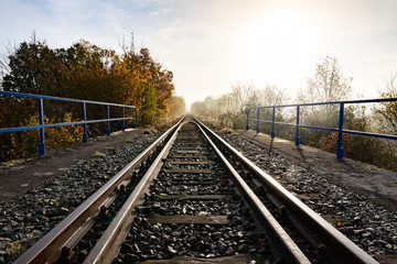 Fototapeta na wymiar Old railroad tracks leading through the bridge. Railway line in Central Europe.