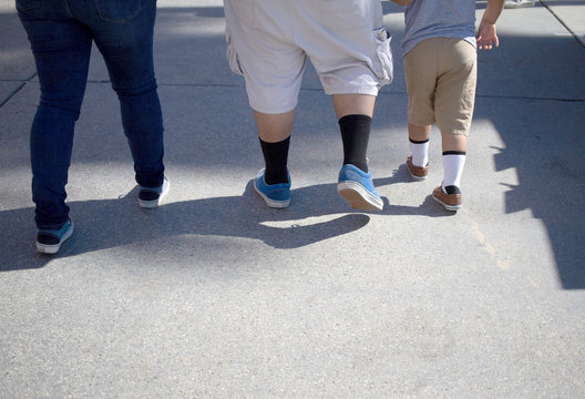 legs of overweight man woman child walking exercise lose weight