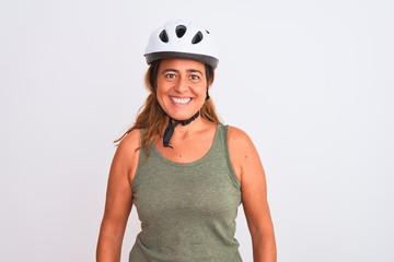 Middle age mature cyclist woman wearing safety helmet over isolated background with a happy and cool smile on face. Lucky person.