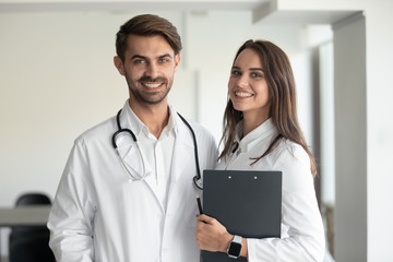 Smiling professionals male doctor and female nurse looking at camera