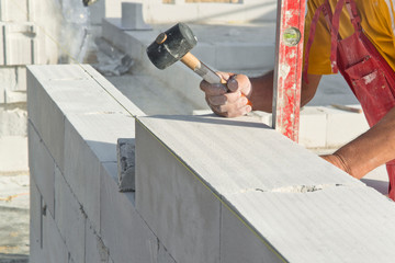 Construction work. Building walls with cellular concrete.