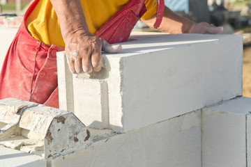 Construction work. Building walls with cellular concrete.