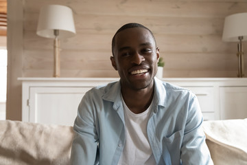 Smiling mixed race young man holding video conference call.