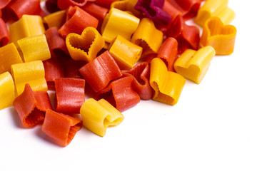 Colorful heart shaped pasta flat lay