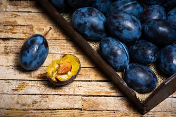 Fresh plums on a wooden table