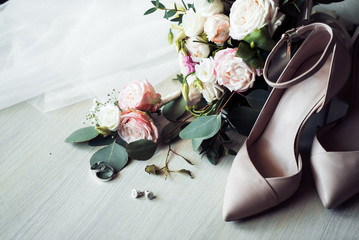 bouquet of bride and shoes on a white table 4