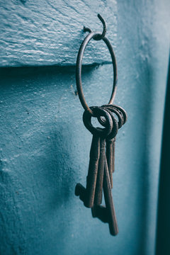 Close-up of old keys hanging on a hook on wall