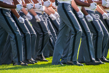 Lower body view of the gray uniform pants of Army cadets as they march - obrazy, fototapety, plakaty