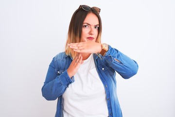 Beautiful woman wearing denim shirt standing over isolated white background Doing time out gesture...