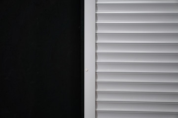white shutters on the black wall