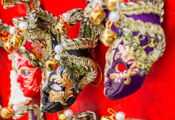 Traditional Venetian mask on the streets of Venice, Italy, isolated on colorful background. 