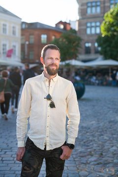 Portrait of man standing on cobblestone street