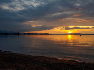 Golden sunset at the sandy beach of lake Chiemsee