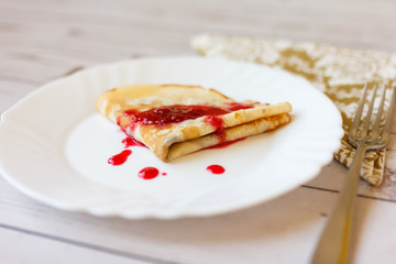 Dessert with raspberry jam, roll appetizing pancakes