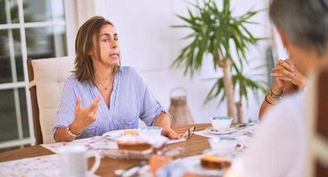 Young beautiful girl smiling happy and confident sitting dinking cup of coffee at terrace