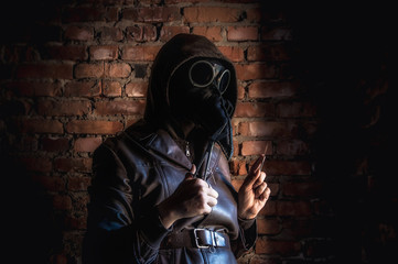 Terrible plague doctor on red brick background. Masked maniac with scalpel and scissors. Halloween and horror