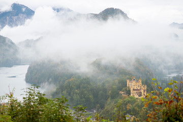 Hohenschwangau castle in autumn with fog in the morning