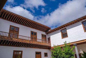 City San Cristobal de La Laguna, Tenerife, Spain. Antique buildings on blue sky background. Colonial style of the city. Houses painted with various bright colors.