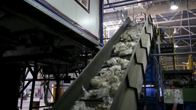 moving conveyor transporter on Modern waste recycling processing plant. Separate and sorting garbage collection. Recycling and storage of waste for further disposal. 