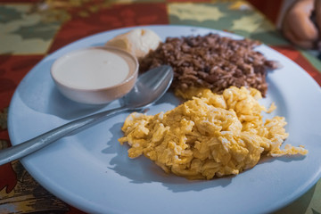 Traditional Breakfast of Nicaragua. Eggs, rice and beans, sour cream and cheese.