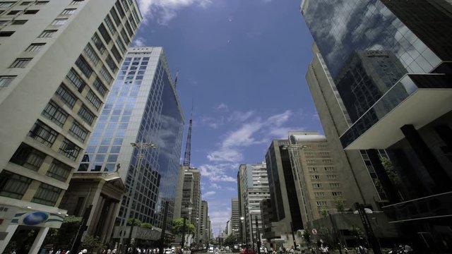 Wide view of a bridge, vehicles and people passing in the most important avenue in sao Paulo, Av Paulista. Brazil