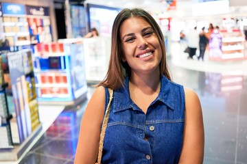 Young traveller woman at the tax free shop at the airport