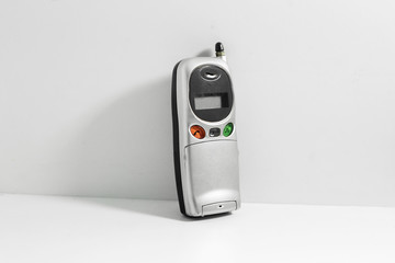 Old cell phone isolated on white background.