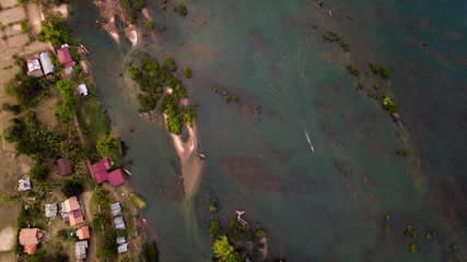 Bird's Eye View of the 4000 Islands with a boat driving on the mekong river delta in laos.