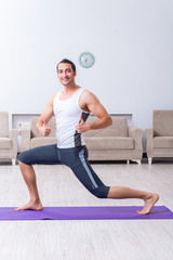 Fototapeta premium Young man training and exercising at home
