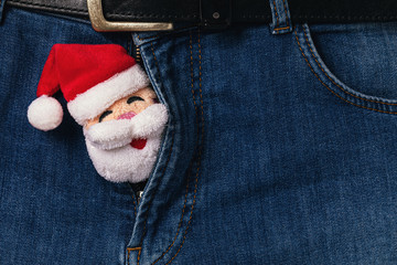 Santa Claus peeps out from the unzipped zipper on jeans. Concept on the topic of intimate relationships - obrazy, fototapety, plakaty