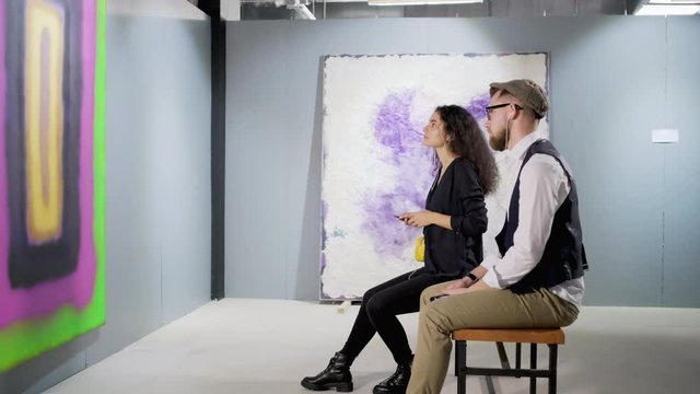 Two art gallery visitors with audio guide