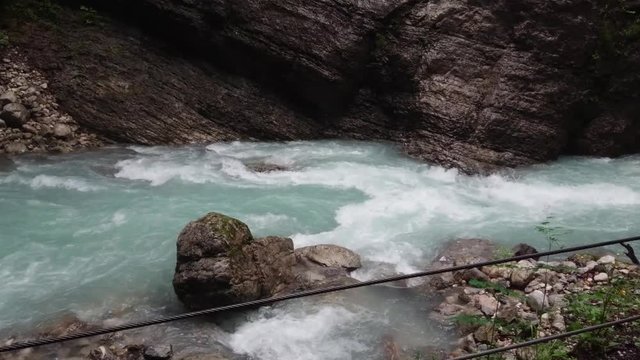 Inside the Partnach Gorge flowing wild water beside the rocks.