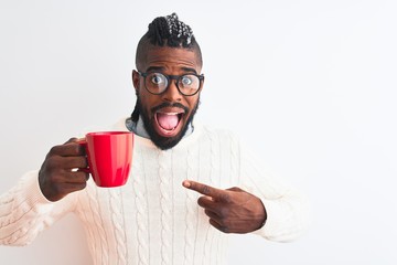 African american man with braids drinking cup of coffee over isolated white background very happy pointing with hand and finger
