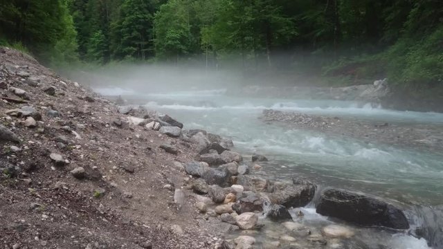 Flowing water in forest with foggy ambiance in Garmisch-Partenkirchen / Germany.